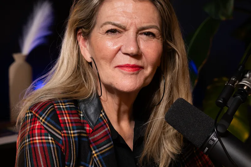 Invitée en veste écossaise au micro dans un studio à Genève