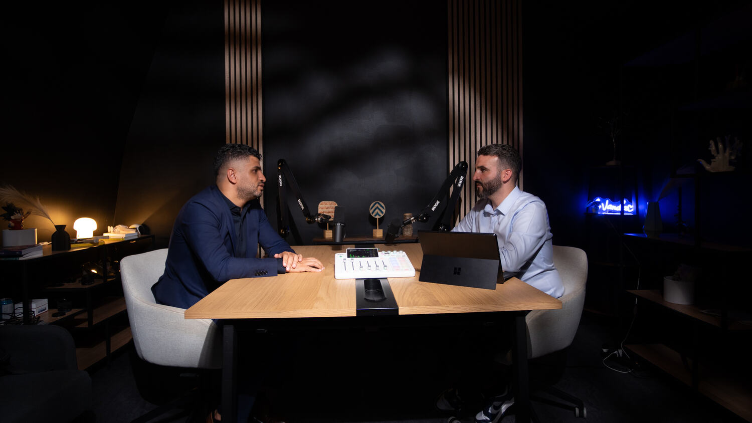 Two guests mid-session in Studio Rhône, microphones and console on the table